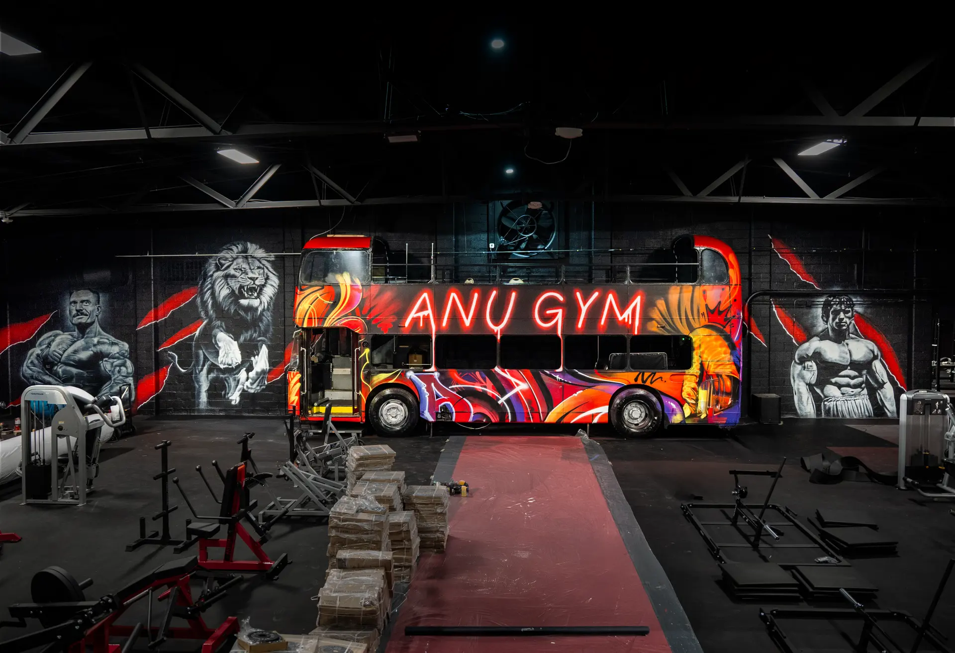 Anu Gym interior with custom bus and murals