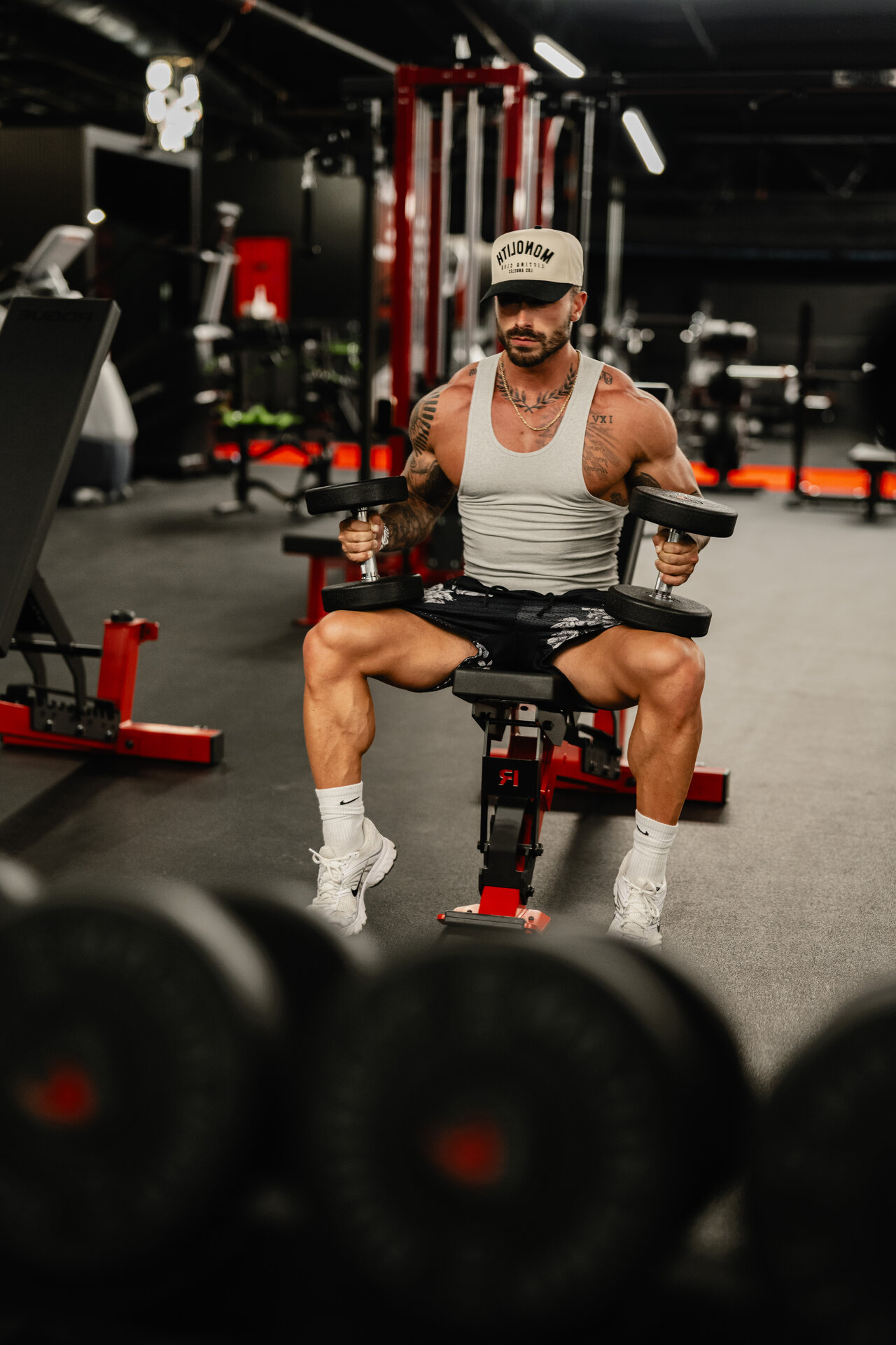 Athlete training with dumbbells on the gym floor